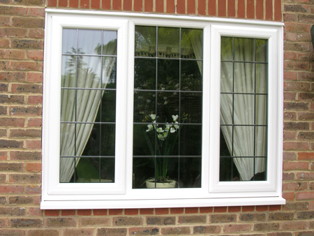 White casement windows with Georgian bars on a red brick house