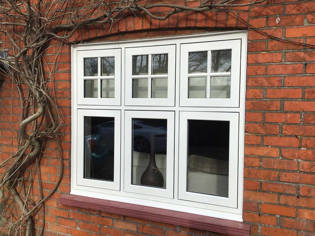 White flush casement window on a red brick wall