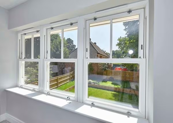 White vertical slider windows with garden view